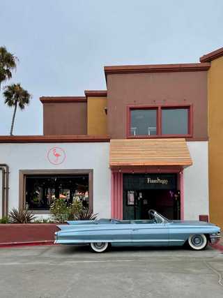 A vintage car in front of a restaurant at Pacific Beach