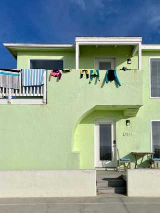 Beach gear drying on a balcony at Pacific Beach