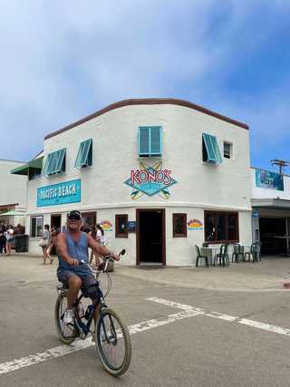 A cheerful cyclist at Pacific Beach