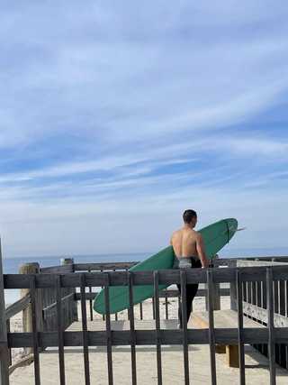 Surfer gazing at the waves on Pacific Beach