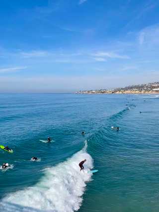Surfers hitting the waves at Pacific Beach