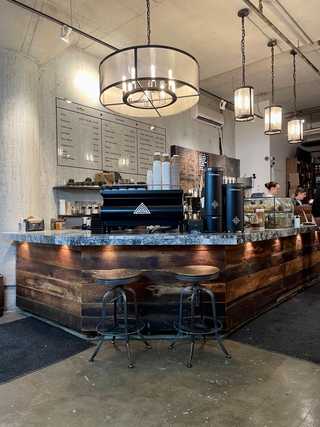 Dark wood coffee counter at Arvo