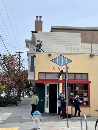 People outside Atlas Cafe in Mission