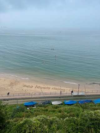 Thoughtprovoking sealevels rising message on the beach
