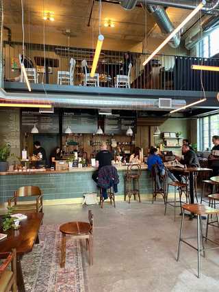 Casual window seat with vintage cushion at Carbonic Coffee