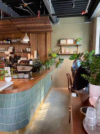 Casual window seat with vintage cushion at Carbonic Coffee