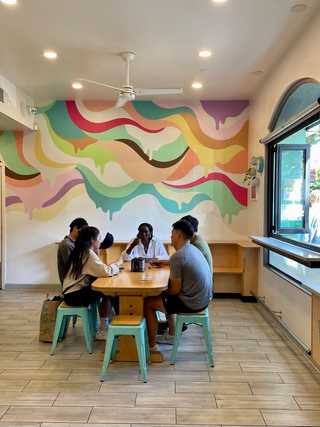 Patrons eating ice cream in a colourful setting