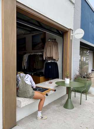 A girl sitting by an open window at Bird Rock neighbourhood