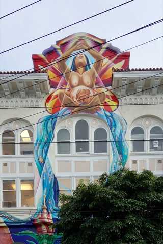 A graffiti depicting a birth painted on a building