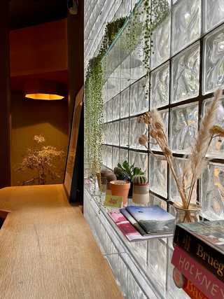 A glass wall and art books at Boxcar Social