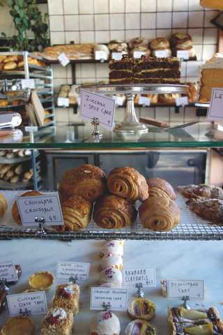 People sitting in the sun outside a coffee shop