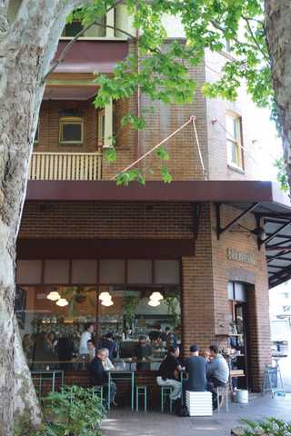 People sitting in the sun outside a coffee shop