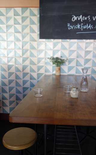 People sitting in the sun outside a coffee shop