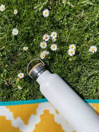 White water bottle on a picnic blanket