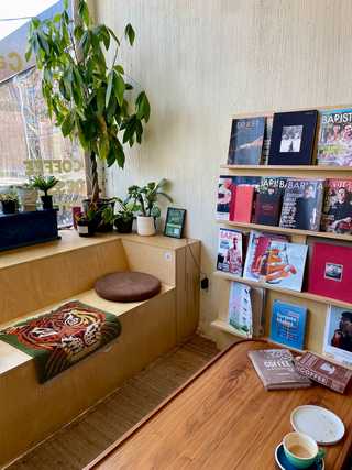 Casual window seat with vintage cushion at Carbonic Coffee