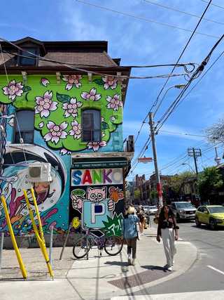 A colourful graffiti on a wall of a shop