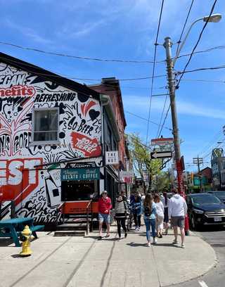 A busy local street with people passing by
