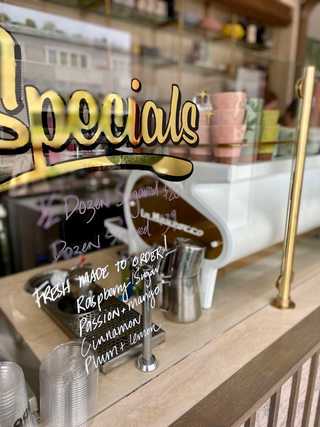 Doughnut menu written on a window at Dodo Bird Donuts at Bird Rock