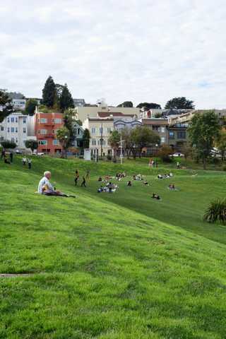 Man playing a guitar at Dolores Park