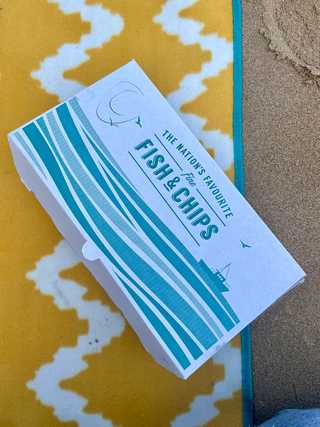 Fish and chips on a picnic blanket