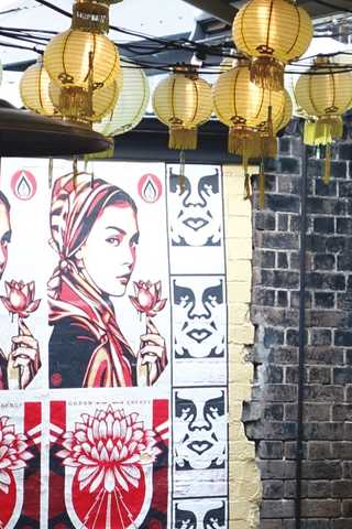 People sitting in the sun outside a coffee shop