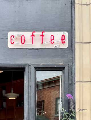 A coffee shop sign advertising coffee