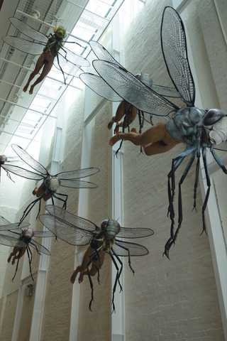 People sitting in the sun outside a coffee shop