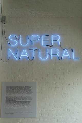 People sitting in the sun outside a coffee shop