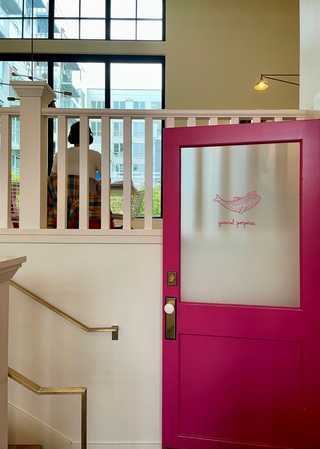 A bright pink door inside General Porpoise