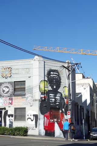 People sitting in the sun outside a coffee shop