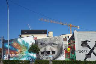 People sitting in the sun outside a coffee shop