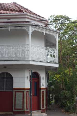 People sitting in the sun outside a coffee shop