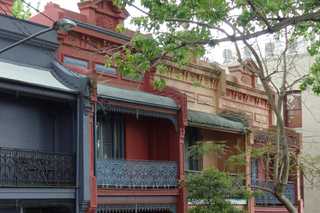 People sitting in the sun outside a coffee shop