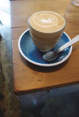 People sitting in the sun outside a coffee shop