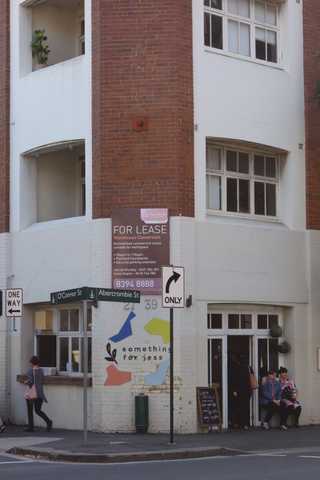 People sitting in the sun outside a coffee shop
