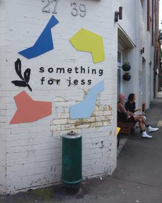 People sitting in the sun outside a coffee shop