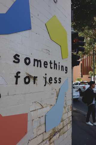 People sitting in the sun outside a coffee shop