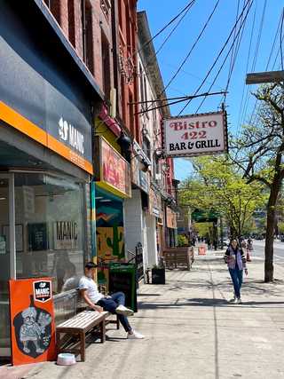 A guy enjoying a coffee in front of a cafe
