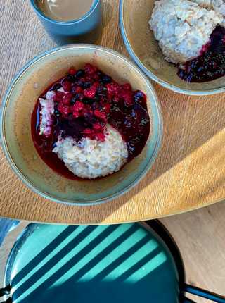 A close up of a berry porridge with morning rays of sunshine