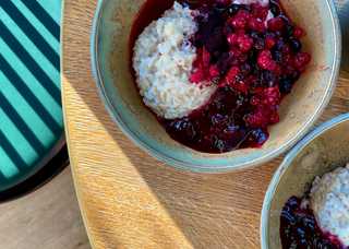 A close up of a berry porridge with morning rays of sunshine