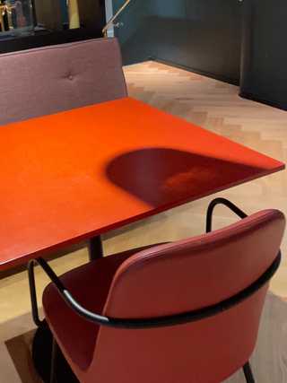 A close up of a orange retro table at the breakfast room