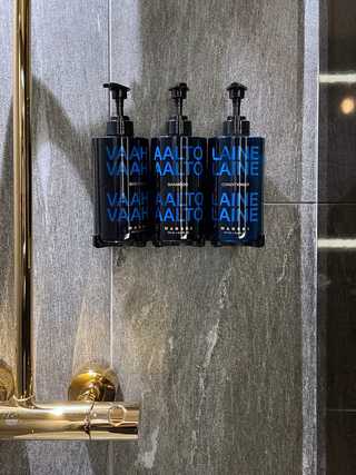 Refillable soap bottles in a dark bathroom