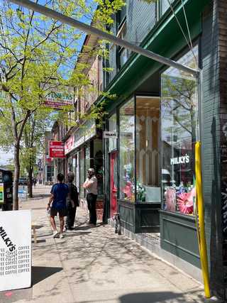 In front of a local cafe located on a buzzing street
