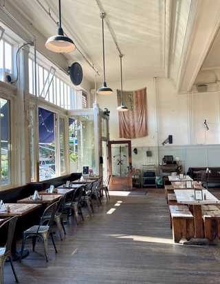 The pretty indoors of Oddfellows Cafe and Bar bathed in light