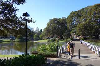 People sitting in the sun outside a coffee shop