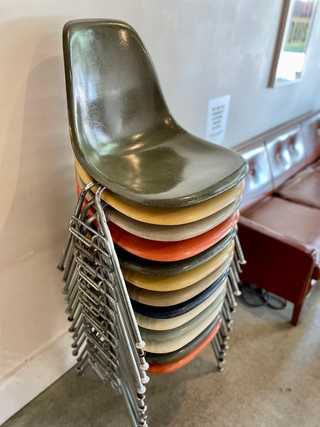 A pile of colourful plastic chairs at Porchlight Coffee