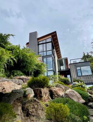 A sleek, ultramodern house on a rocky hill