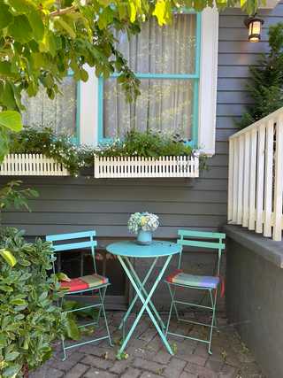 Cosy blue table and chairs outside someone's house