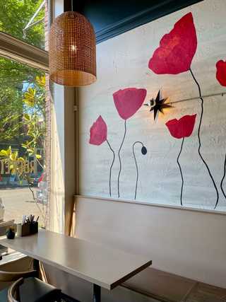 Table against a flower mural at Rocket Taco