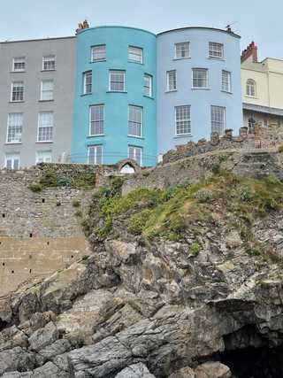 Colourful houses on top of a rocky cliff